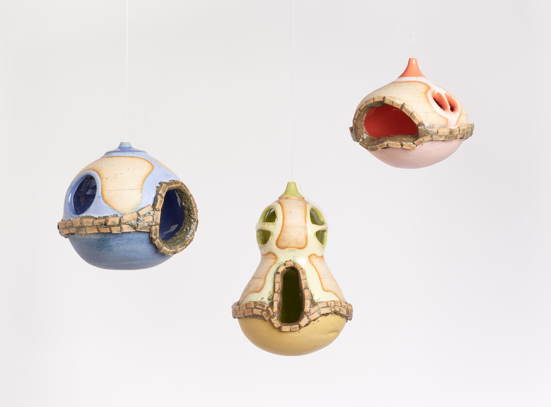 Set of three hanging ceramic vessels.